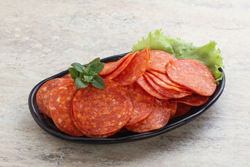 Sliced pepperoni sausage in the bowl