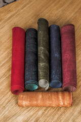 Fototapeta na wymiar Rolls of genuine leather on a wooden table