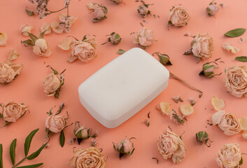 A bar of fragrant organic soap with dried flowers and rose leaves. The concept of hygiene and skin care.
