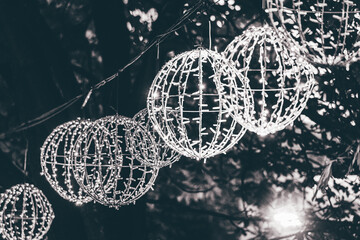 light garlands in the form of a ball hung on a tree