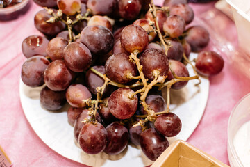 Red grapes on a plate on a festive table
