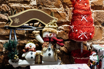Composition of christmas toys on a brown brick wall background close-up