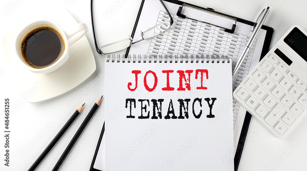 Poster joint tenancy text on the paper with calculator, notepad, coffee ,pen with graph