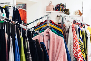 Different women's clothing on hangers in the store