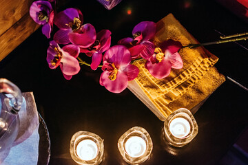 Composition of flowers and candles on a dark background