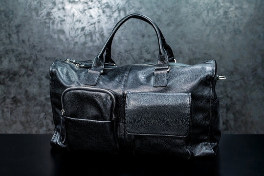 Black leather bag on a dark background