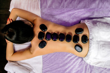 Spa treatments with stones on a girl horizontal