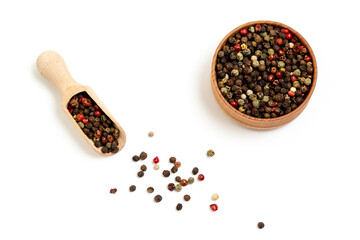 Mix of different peppercorns in a pepper shaker and a rash, isolated on a white background. Aromatic spices for cooking.