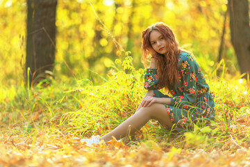 Teen girl in dress in autumn forest - 484652614