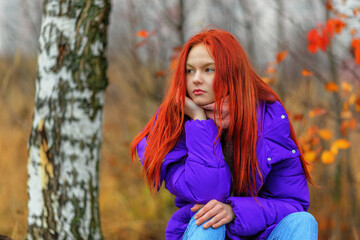Teen girl in violet jacket in autumn day - 484652615
