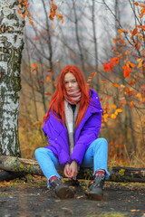 Teen girl in violet jacket in autumn day - 484652616