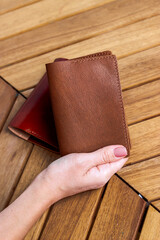 Passport cover made of genuine leather on a wooden background
