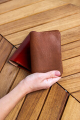 Passport cover made of genuine leather on a wooden background