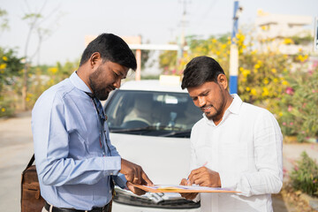 cab driver signing on insurance or loan agreement documents in front of car - concept approval of vehical or personal loan, self employment and financial support.