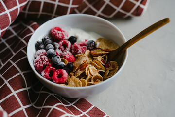 Hearty breakfast with frozen blackcurrant berries and raspberries.