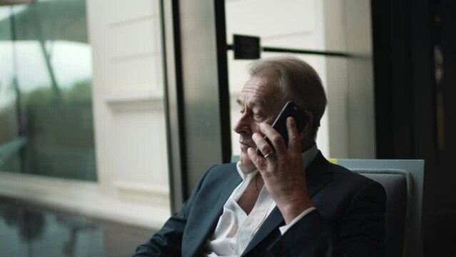 old businessman talking on cell phone