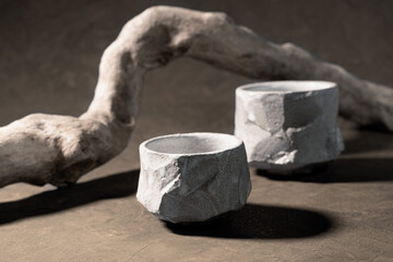 Two empty bowls-tyawan, handmade from Japanese-style ceramics. Wooden, textured, dry branch. Wabi...