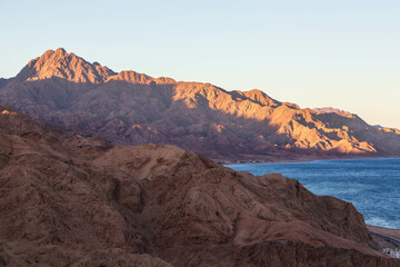 Aerial view of Sinai mountains and Red Sea at sunset. Dahab town, Sinai peninsula, Egypt