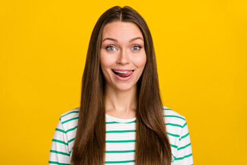 Photo of pretty childish lady dressed striped shirt smiling stick out isolated yellow color...