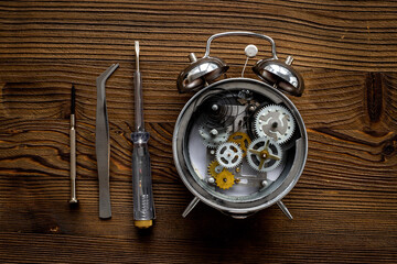 Open alarm clock with watch mechanism - steel gears and wheels closeup