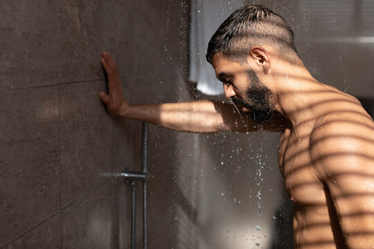 Young Guy Taking Shower In Modern Bathroom