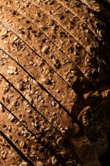 Close up view of sliced wholemeal bread with seeds on rustic wooden table