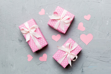 Valentine day composition Background: red gift box with bow and heart. Christmas present. View from above. Holday greeting card