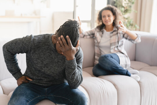African-american wife crying arguing scolding at her husband at home. Misunderstanding between partners. Cheating, divorce, breakup. Abuse, gaslighting. Psychological therapy
