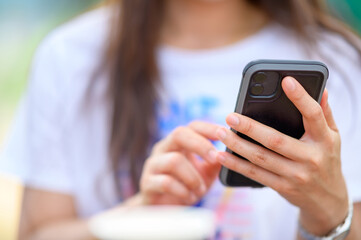 close up Woman checking email with mobile phone at a coffee shop