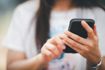 close up Woman checking email with mobile phone at a coffee shop