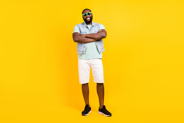Fototapeta premium Full length body size view of attractive cheery guy hipster folded arms isolated over bright yellow color background