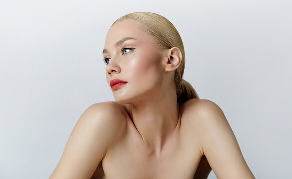 Portrait of a young woman with natural make-up and natural styling.Blond with slicked hair.Advertising natural cosmetics.Advertising a beauty salon.Cosmetics for care, face and body skin care.
