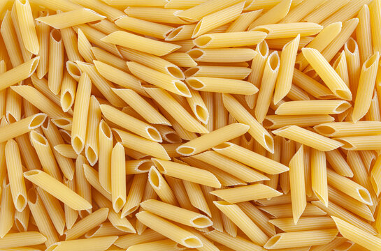 Uncooked penne pasta background