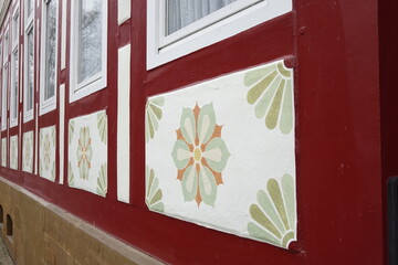 Bottom of traditional German framework houses with red framework and colourfully painted antique flower ornaments (horizontal), Bad Salzdetfurth, Lower Saxony, Germany