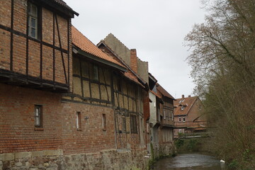 Fototapeta premium Back sides of old German red brick and framework houses in 'Klein Venedig' (Little Venice) at River Lamme (horizontal), Bad Salzdetfurth, Lower Saxony, Germany