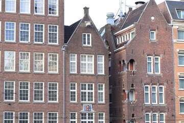 Fototapeta na wymiar Amsterdam Damrak Street Brick Building Facades, Netherlands