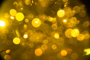 abstract orange-yellow background, glare and blur, surface ripples, radiance and sparks
