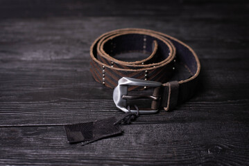 brown leather men's belt on a dark background