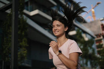 Fit athlete woman in sportswear outdoors. Young woman jogging outside.