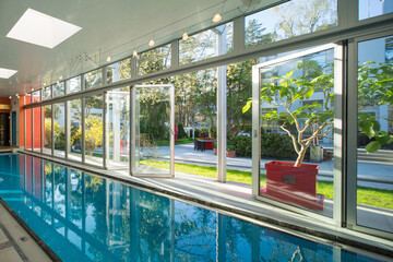Fototapeta na wymiar Modern interior of luxury private house. Swimming pull in cottage.