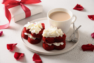 Red velvet cake in shape of hearts and coffee for Valentine's day on white background. Tasty...