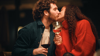Loving Mixed Race Couple Sitting Together on an Outdoors Terrace on a Warm Summer Evening. Beautiful Caucasian Ginger Man and Black Woman with Afro Hair Kiss, Talk, Relax on Weekend, Have Fun.