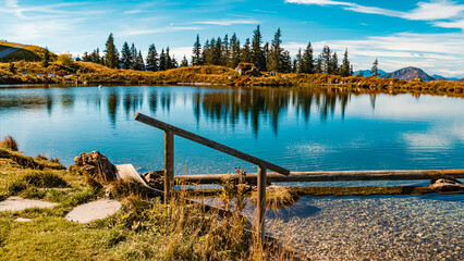 Fototapeta premium Beautiful alpine summer view with reflections at the famous Fleckalm near Kitzbuehel, Tyrol, Austria