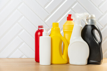 Cleaning concept. Set of cleaning detergents in colored plastic bottles. Clean house.