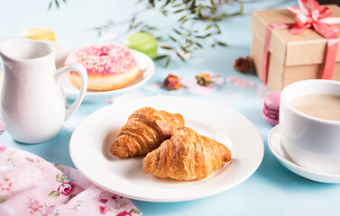 Fresh baked croissants and cup of tea. Healthy lifestyle concept.