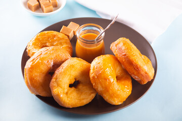 Homemade delicious donuts with caramel syrup sauce on the plate