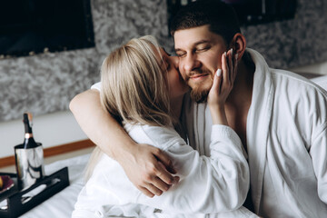 Fototapeta premium Morning of a young married couple in a hotel room. Honeymoon.