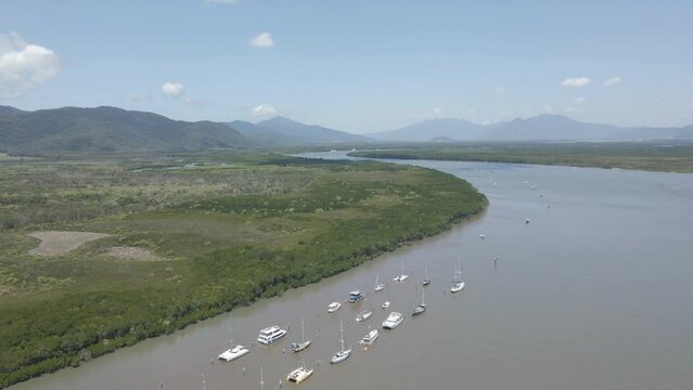 Row Of Boats Anchored At Chinaman Creek With Trinity Forest Reserve - Nature Reserve Near Cairns, Australia. - aerial