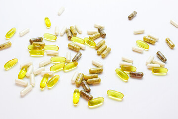 capsules and tablets scattered on the table on a light background macro, dietary supplements, omega 3, fish fat