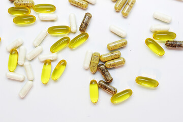 capsules and tablets scattered on the table on a light background macro, dietary supplements, omega 3, fish fat